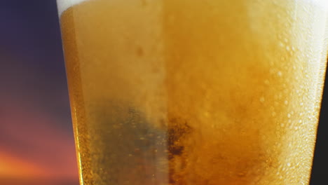 slow-motion-Macro-cold-beer-is-poured-into-a-glass-with-perspiration.-Beer-bubbles-rise-to-the-surface.